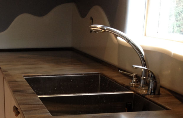 Durable solid surface backsplashes instead of tiles.